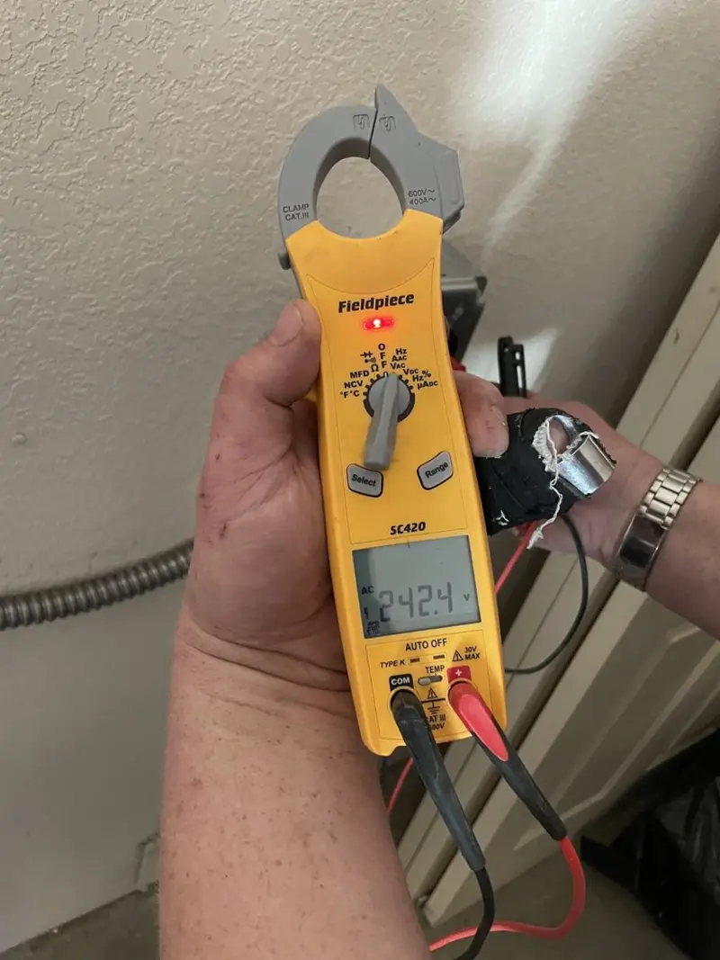 Voltage testing with clamp meter during Recessed Lighting Installation in North Providence